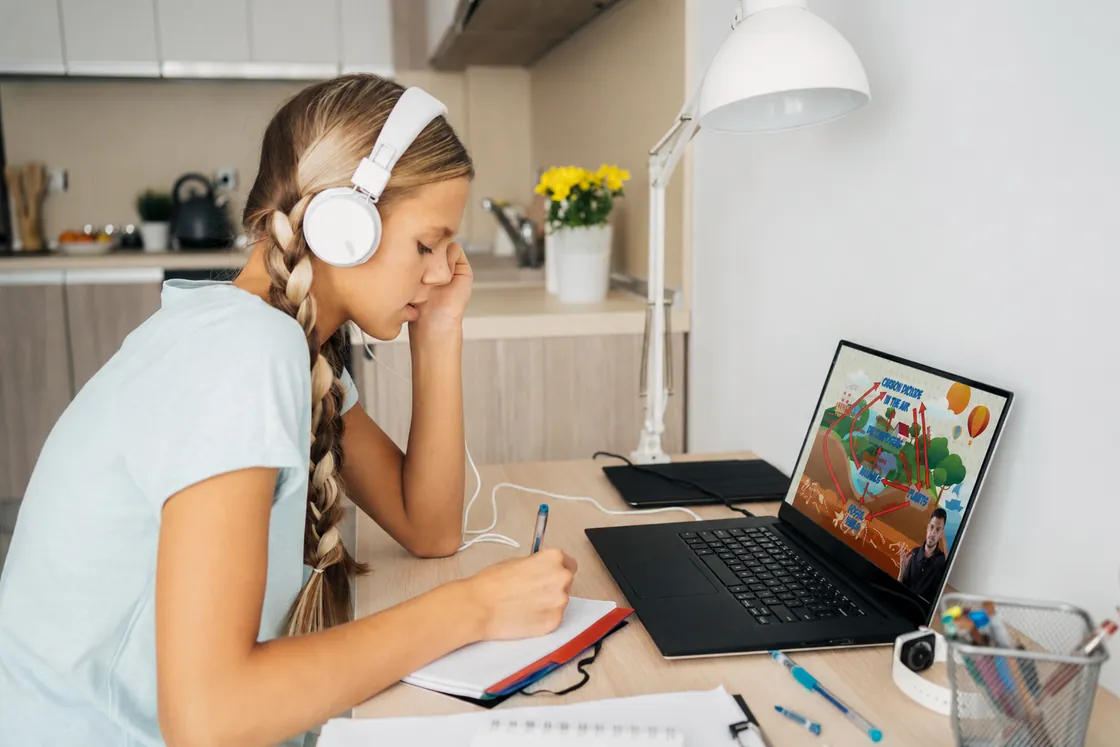 Student studying at a laptop with headphones